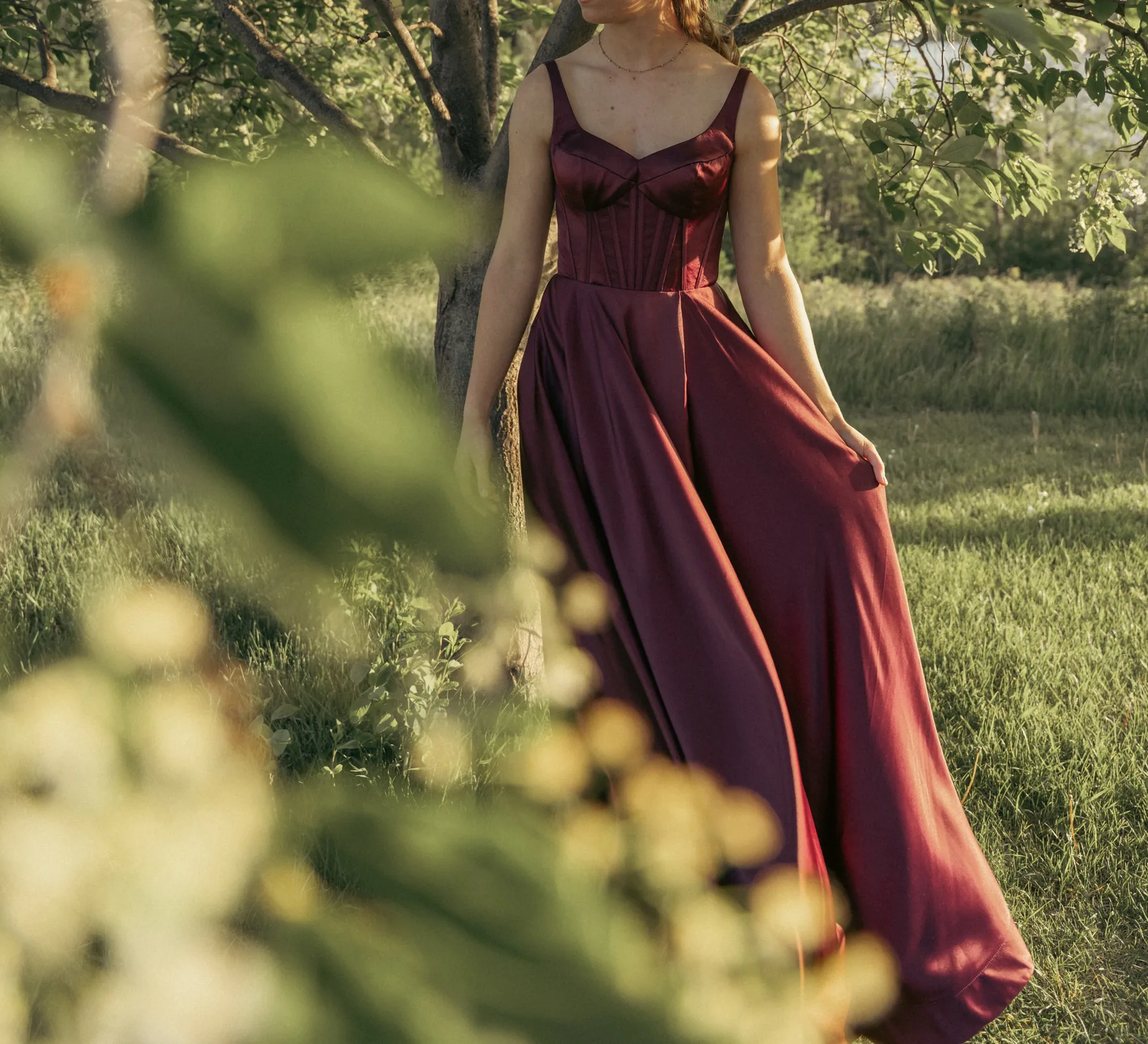 Burgundy formal dress photographed outdoors
